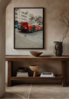 Een CollageDepot Ferrari 812 Competizione Schilderij wordt elegant weergegeven met behulp van een magnetisch ophangsysteem op een beige muur boven een houten consoletafel. Op de tafel staan enkele decoratieve voorwerpen, waaronder een kom, een vaas en enkele boeken. Aan de rechterkant zit ook een tak in een vaas.,Zwart